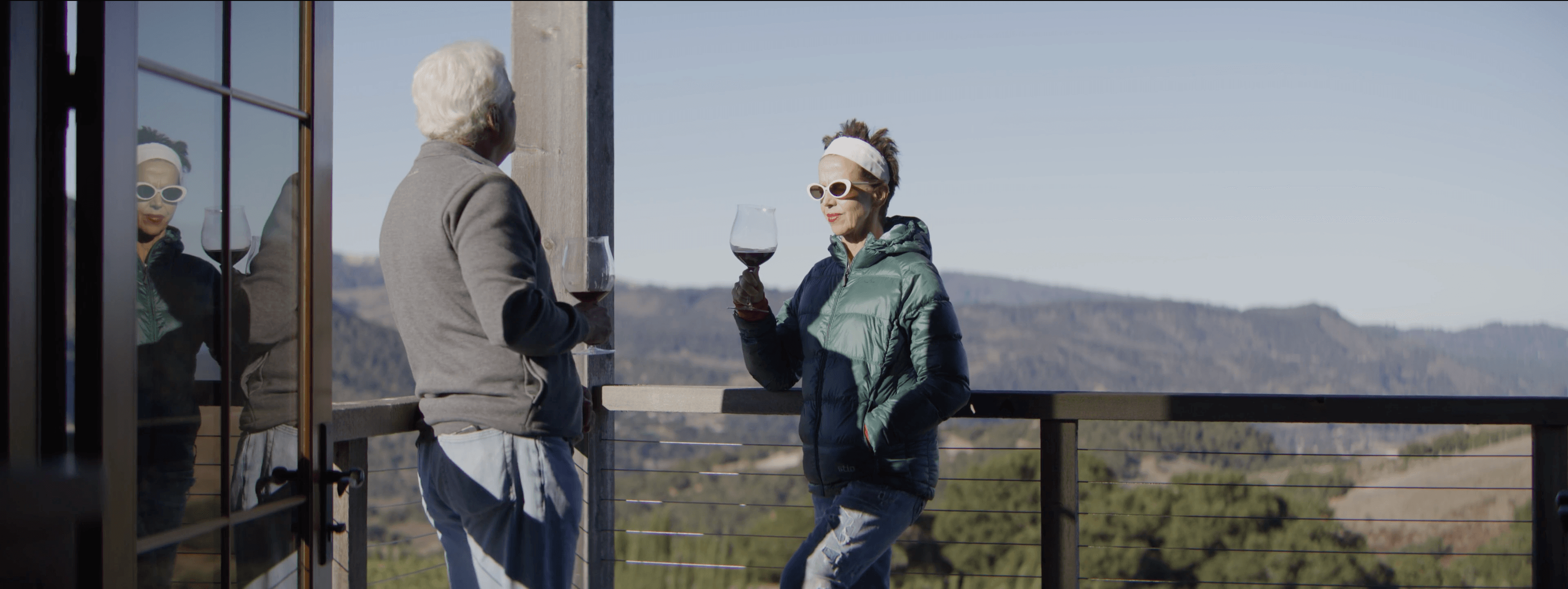 Andy and Margaret Paul toasting wine on the deck at Diamond T Ranch